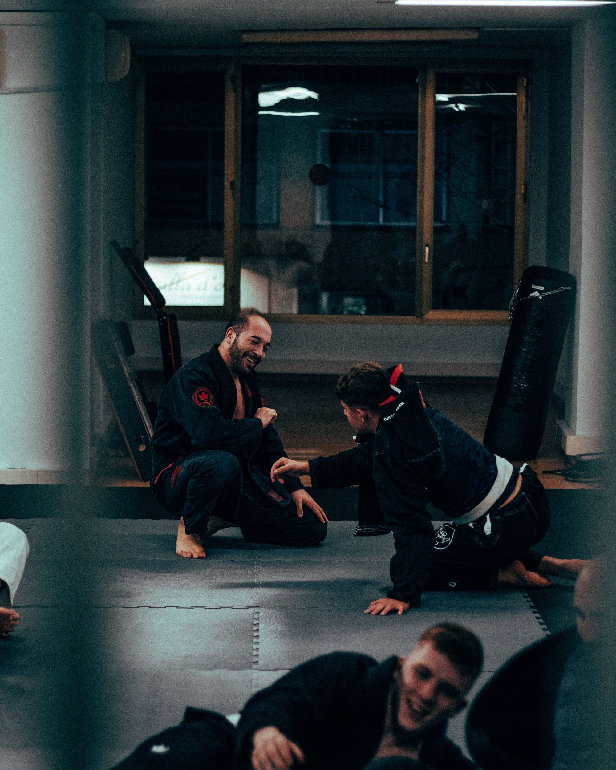Students training together on the mats at a martial arts academy